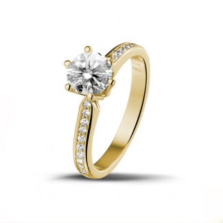 One - 1.00 carat solitaire diamond ring in yellow gold with side diamonds