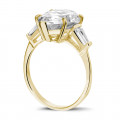 Ring in yellow gold with pear shaped diamond and taper cut baguette diamonds
