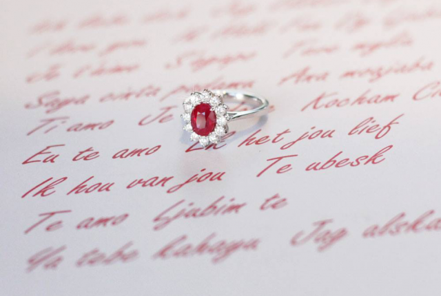 Ring with oval cut ruby lying on a letter – BAUNAT