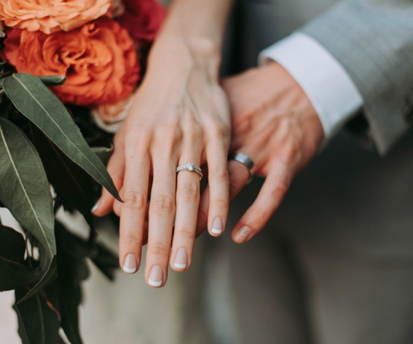 Bride and groom showing there wedding rings 