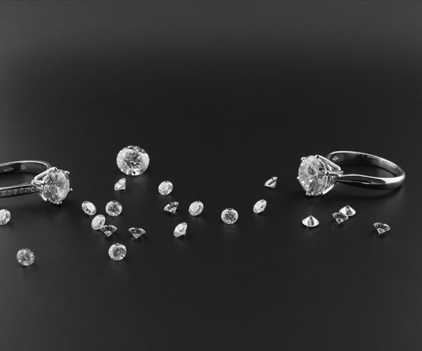 2 diamond rings on black background with smaller diamonds