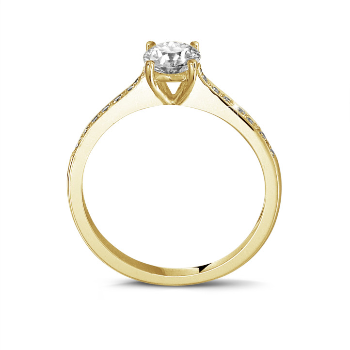 0.70 carat solitaire ring in yellow gold with four prongs and side diamonds