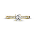 0.70 carat solitaire ring in yellow gold with four prongs and side diamonds