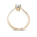 0.70 carat solitaire ring in red gold with four prongs and side diamonds