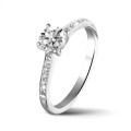 0.70 carat solitaire ring in platinum with four prongs and side diamonds