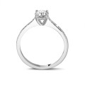 0.70 carat solitaire ring in white gold with four prongs and side diamonds