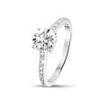 0.90 carat solitaire ring in platinum with four prongs and side diamonds