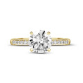 1.25 carat solitaire ring in yellow gold with four prongs and side diamonds