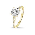 1.50 carat solitaire ring in yellow gold with four prongs and side diamonds