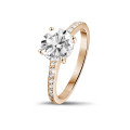 1.50 carat solitaire ring in red gold with four prongs and side diamonds