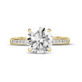 2.00 carat solitaire ring in yellow gold with four prongs and side diamonds