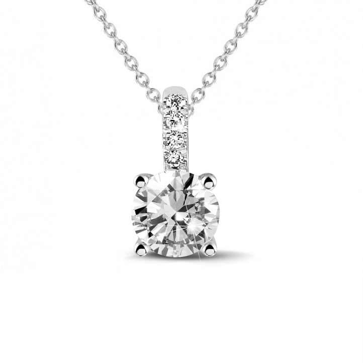 0.70 carat solitaire pendant in platinum with four prongs and round diamonds