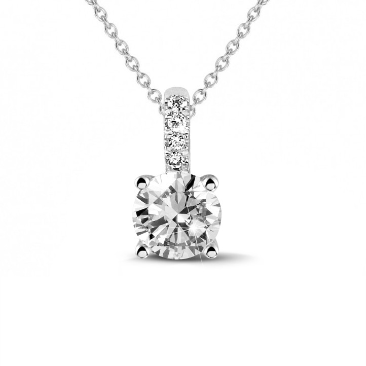 0.90 carat solitaire pendant in platinum with four prongs and round diamonds