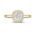 1.20 carat solitaire halo ring with a cushion diamond in yellow gold with round diamonds