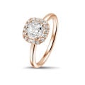 1.50 carat solitaire halo ring with a cushion diamond in red gold with round diamonds