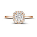 1.50 carat solitaire halo ring with a cushion diamond in red gold with round diamonds