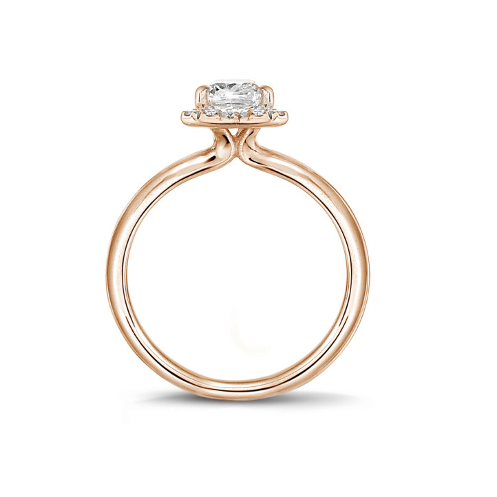 0.70 carat solitaire halo ring with an emerald cut diamond in red gold with round diamonds