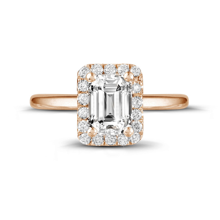 0.70 carat solitaire halo ring with an emerald cut diamond in red gold with round diamonds