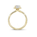 0.70 carat solitaire halo ring with an emerald cut diamond in yellow gold with round diamonds