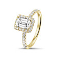 1.00 carat solitaire halo ring with an emerald cut diamond in yellow gold with round diamonds