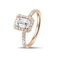 1.50 carat solitaire halo ring with an emerald cut diamond in red gold with round diamonds