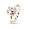 2.00 carat solitaire halo ring with an emerald cut diamond in red gold with round diamonds