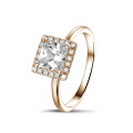 0.70 carat solitaire halo ring with a princess diamond in red gold with round diamonds