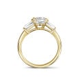 1.00 carat trilogy ring in yellow gold with a round diamond and tapered baguettes