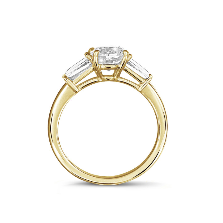1.00 carat trilogy ring in yellow gold with a round diamond and tapered baguettes