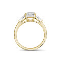 1.00 carat trilogy ring in yellow gold with a princess diamond and tapered baguettes