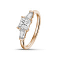 1.00 carat trilogy ring in red gold with a princess diamond and tapered baguettes
