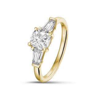 1.00 carat trilogy ring in yellow gold with a cushion diamond and tapered baguettes