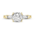 1.00 carat trilogy ring in yellow gold with a cushion diamond and tapered baguettes