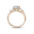 1.00 carat trilogy ring in red gold with a cushion diamond and tapered baguettes