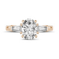 1.00 carat trilogy ring in red gold with oval diamond and tapered baguettes