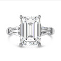 Bespoke trilogy ring with an emerald cut diamond and tapered baguettes