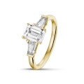 2.00 carat trilogy ring in yellow gold with an emerald cut diamond and tapered baguettes