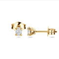 0.30 carat solitaire earrings with oval cut diamonds in yellow gold