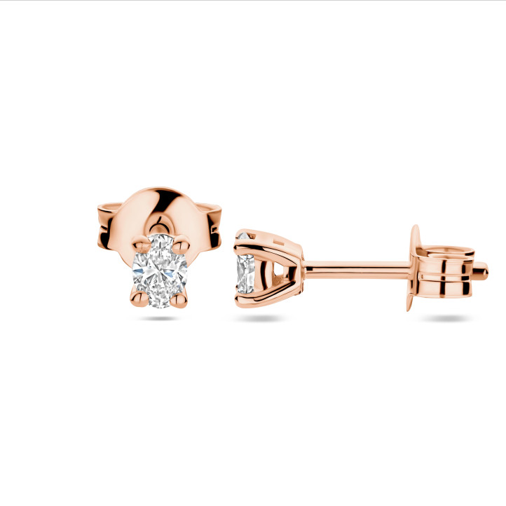 0.30 carat solitaire earrings with oval cut diamonds in red gold