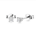 0.30 carat solitaire earrings with cushion cut diamonds in white gold