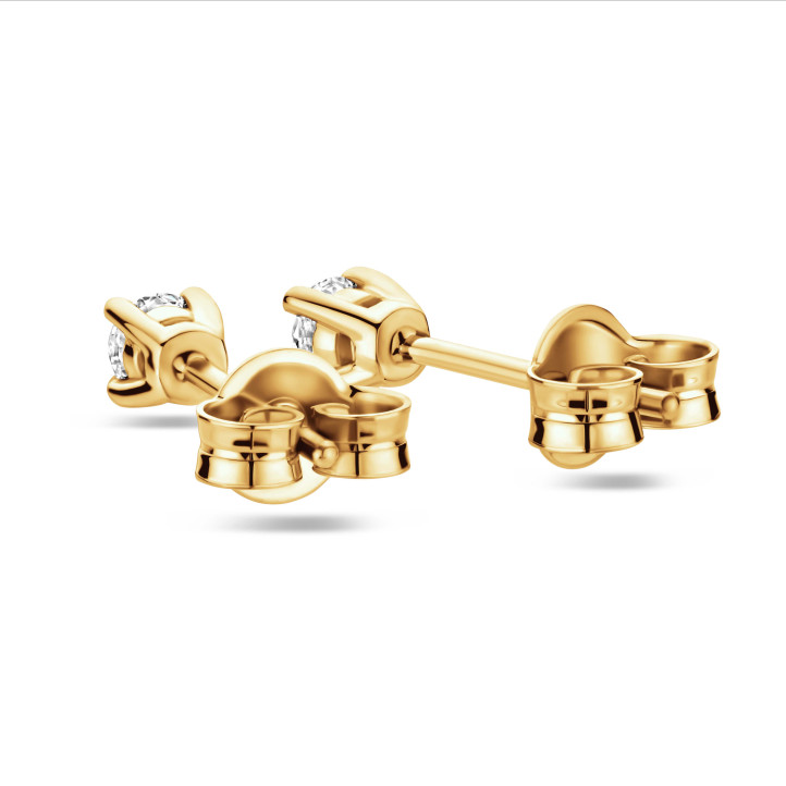 0.30 carat solitaire earrings with round cut diamonds in yellow gold
