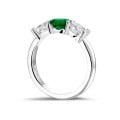Trilogy ring in white gold with a central emerald and 2 round diamonds
