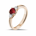 Trilogy ring in red gold with a central ruby and 2 round diamonds