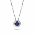 Halo necklace in platinum with a central sapphire and round diamonds