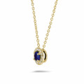 Halo necklace in yellow gold with a central sapphire and round diamonds