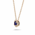 Halo necklace in red gold with a central sapphire and round diamonds