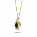 Entourage pendant in yellow gold with oval sapphire and round diamonds