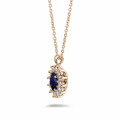 Entourage pendant in red gold with oval sapphire and round diamonds