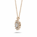 1.85 carat entourage pendant in red gold with oval and round diamonds