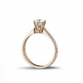 0.70 carat solitaire diamond ring in red gold with side diamonds